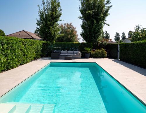 a swimming pool in the backyard of a house at Fortuna in Palazzo Vianello