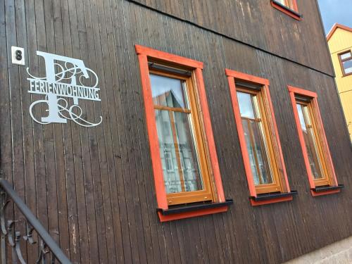 a building with three windows on the side of it at Ferienwohnung Fessel in Hasselfelde