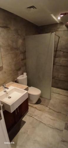 a bathroom with a sink and a toilet at Bella by the Sea in Sowayma