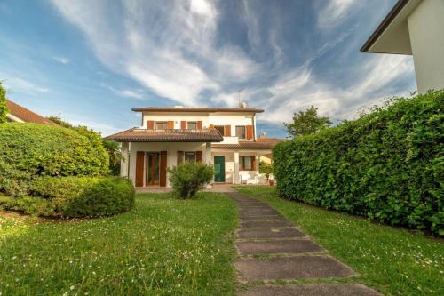 a house with a pathway in front of a yard at Aurora in Caleri