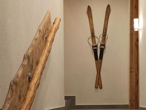 two pieces of wood hanging on a wall at Bergfee Natur Appartements in Nesselwängle