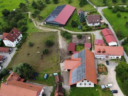 an aerial view of a house with a solar roof at Hofgut Bentele in Deggenhausertal
