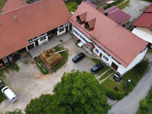 an aerial view of a house with cars parked in a parking lot at Hofgut Bentele in Deggenhausertal