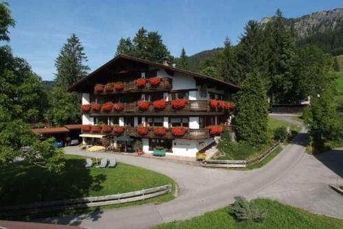 a large building with flowers on the front of it at Berger Hof in Tannheim