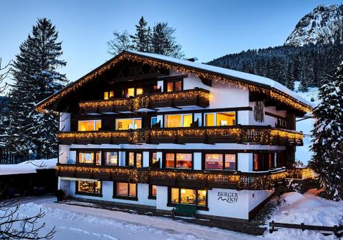 a building with christmas lights on it in the snow at Berger Hof in Tannheim