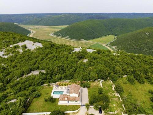 an aerial view of a house in the middle of a forest at Villa Fortuna - Private Pool and Garden Retreat in Labin