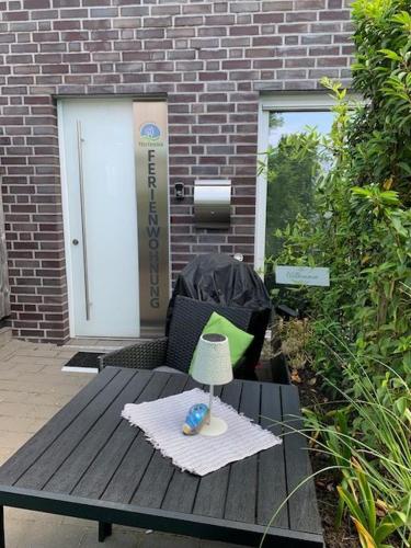 a picnic table with a lamp on top of it at Ferienwohnung Teutoblick Leeden in Tecklenburg