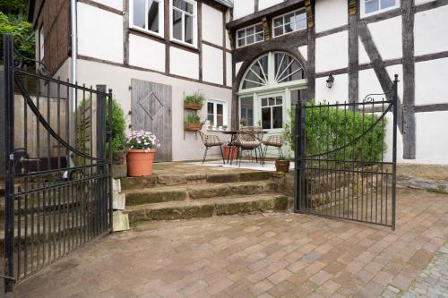 an entrance to a house with a wrought iron gate at MispelFachwerkOase in Tecklenburg