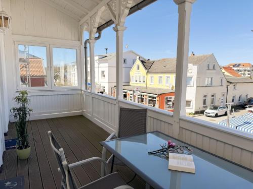 a porch with a table and chairs on a balcony at Villa Minna Whg 06 mit Balkon in Göhren
