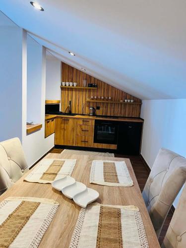 a living room with a table and two chairs at Forest home in Konjic