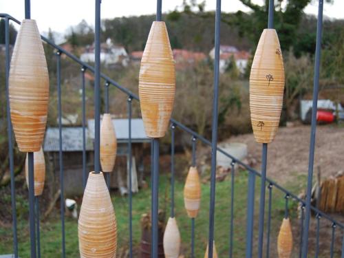 a bunch of cones hanging on a fence at Ferien am Roten Haus in Buckow