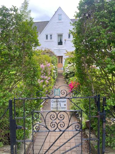 an entrance to a white house with a gate at CarMichael in Edinburgh
