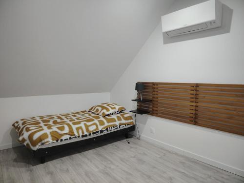 a bedroom with a bed with a brown and white comforter at Jauxvial 2 in Jaux