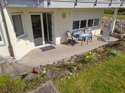 a patio with a table and chairs in front of a house at Ferienwohnung Groß in Bermatingen