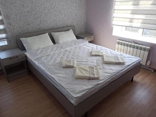a bed with two pillows on it in a bedroom at Мотель Эмир in Pokrovka