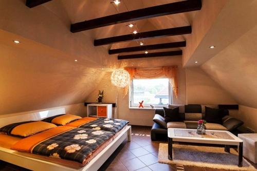 a bedroom with a large bed and a couch at Ferienwohnung Verena Wunderlich in Schlepzig