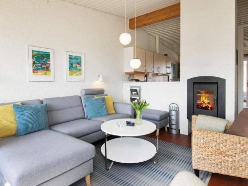 a living room with a couch and a table at 6 person holiday home on a holiday park in Sæby in Sæby