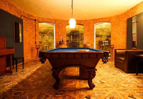 a large room with a pool table in it at Gutshaus Gevezin in Blankenhof