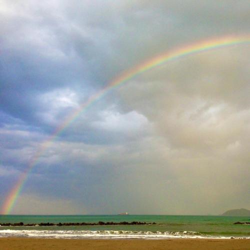 a rainbow in the sky over the beach at 音毬 - Otomari - in Miyazu