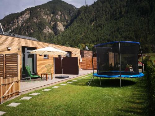 a yard with a house with a trampoline at FREE Ride cabins in Tösens