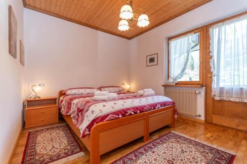 a bedroom with a bed and a window at Ciase Ai Ronch in Falcade