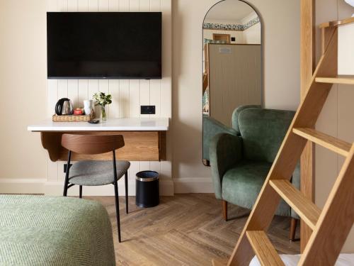 a room with a desk and a chair and a television at The Ashe Hotel in Tralee
