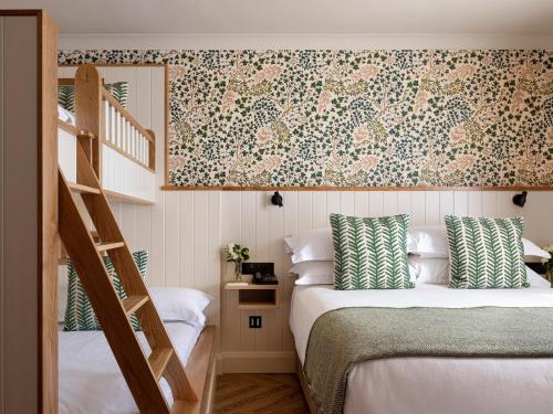 a bedroom with a bunk bed and a staircase at The Ashe Hotel in Tralee