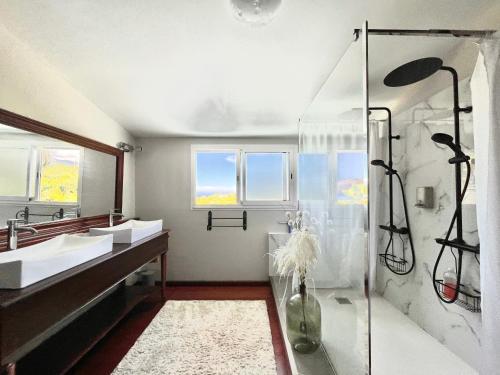 a bathroom with two sinks and a glass shower at Case Christal in Saint-Louis