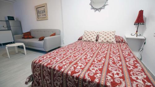 a bedroom with a bed and a couch at El Pozo in Toledo