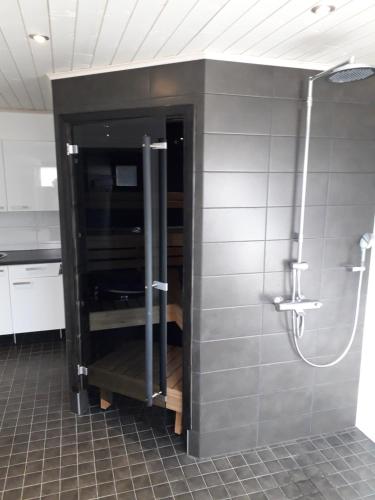 a bathroom with a shower and a sink at Himos Pitkäjärvi in Jämsä