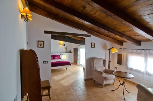 a living room with a bed and a table at La Posada De Santa Ana in Tramacastilla