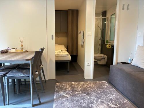 a small apartment with a bed and a table and a bedroom at Greilitz 23 in Gailitz