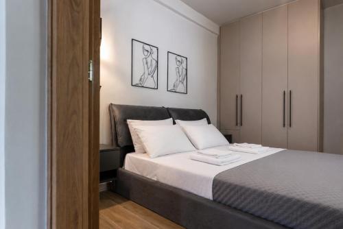 a bedroom with a bed with two towels on it at Latitude 37 Luxe in Kalamata