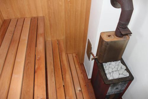 a room with a wooden floor with a wood stove at Kuru Villa in Kuru