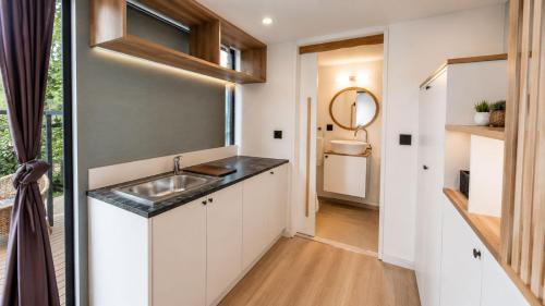 a small kitchen with a sink and a mirror at Alya Hill Bodrum in Bodrum City