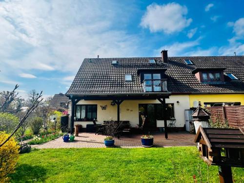 a house with a patio and a yard at Ferienwohnung "Baum" in Rechlin