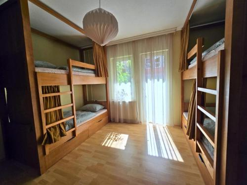 a room with bunk beds and a large window at Good Hostel Prishtina in Prishtinë