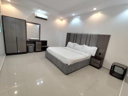 a bedroom with a bed and a tv in it at شاليه سما in Taif
