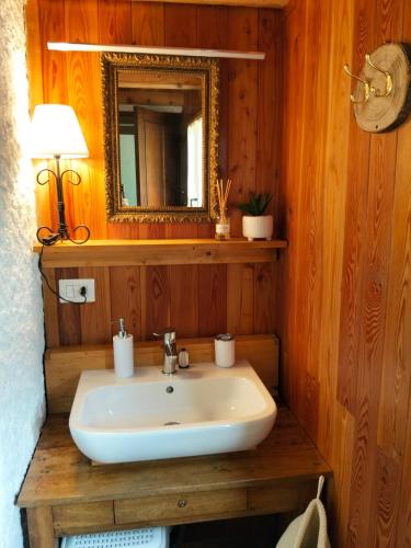 a bathroom with a sink and a mirror at La baita alpina in Scopello