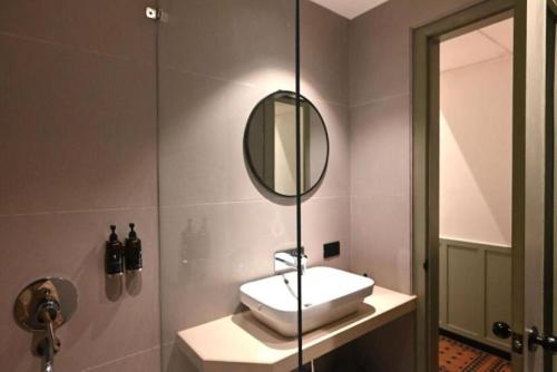 a bathroom with a sink and a mirror at Status Club Resort in Kānpur