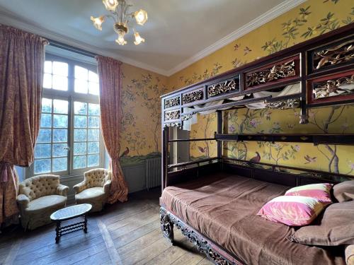 a bedroom with a bunk bed and a chair at Château de Saint-Pois in Saint-Pois