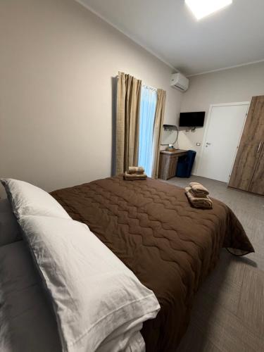 a bedroom with a bed with two towels on it at B&B Nido degli Ulivi in Catanzaro