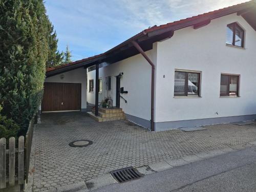 a white house with a gate and a driveway at Gittis Ferienwohnung in Greifenberg