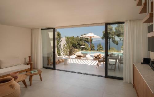 an open living room with a view of a patio at Maritima Villas in Paliouri
