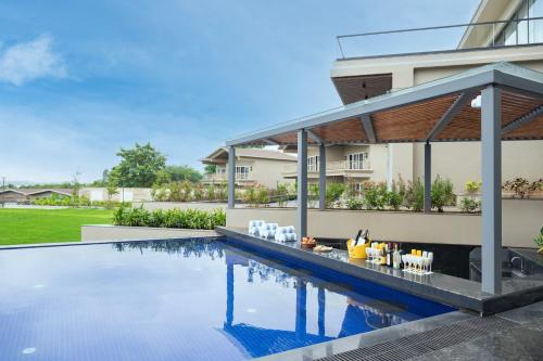 a swimming pool in the backyard of a house at The Haven by Sula in Nashik