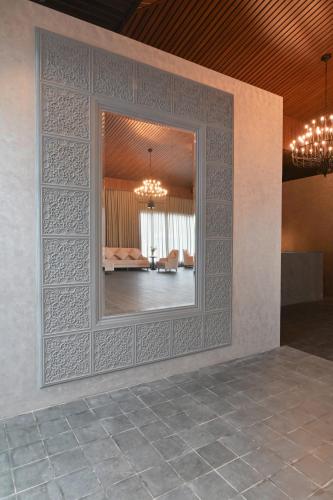 a wall with a mirror in a room at The Haven by Sula in Nashik