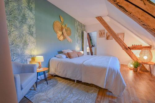 a bedroom with a bed and a blue wall at Gite de l'entente in Macey