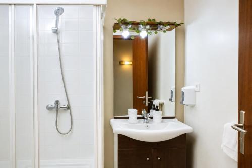 a bathroom with a sink and a shower at AC Hotel in Luanda