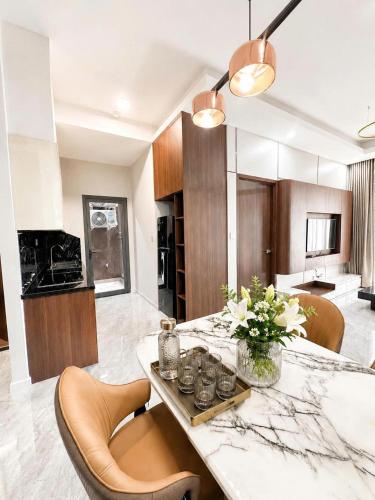 a kitchen with a table with chairs and a counter top at Cara Riverside Cần Thơ- 2 mins GO Cần Thơ in Can Tho