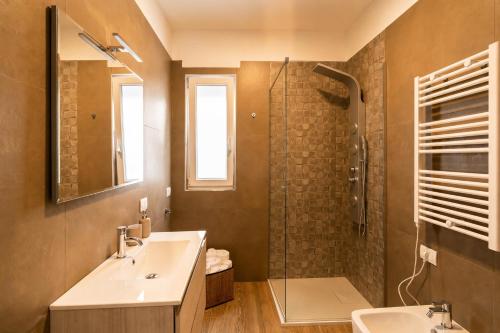 a bathroom with a sink and a shower at Dimore Rosselli Suites in Fasano